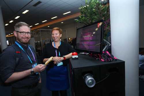 A man and a woman standing at the demo computer for teh Adobe Xd product.