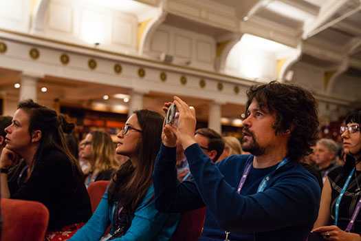 Person taking photo in audience