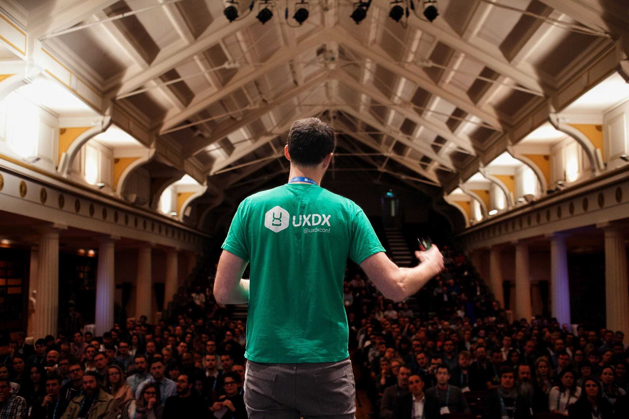 Speaker on stage at UXDX